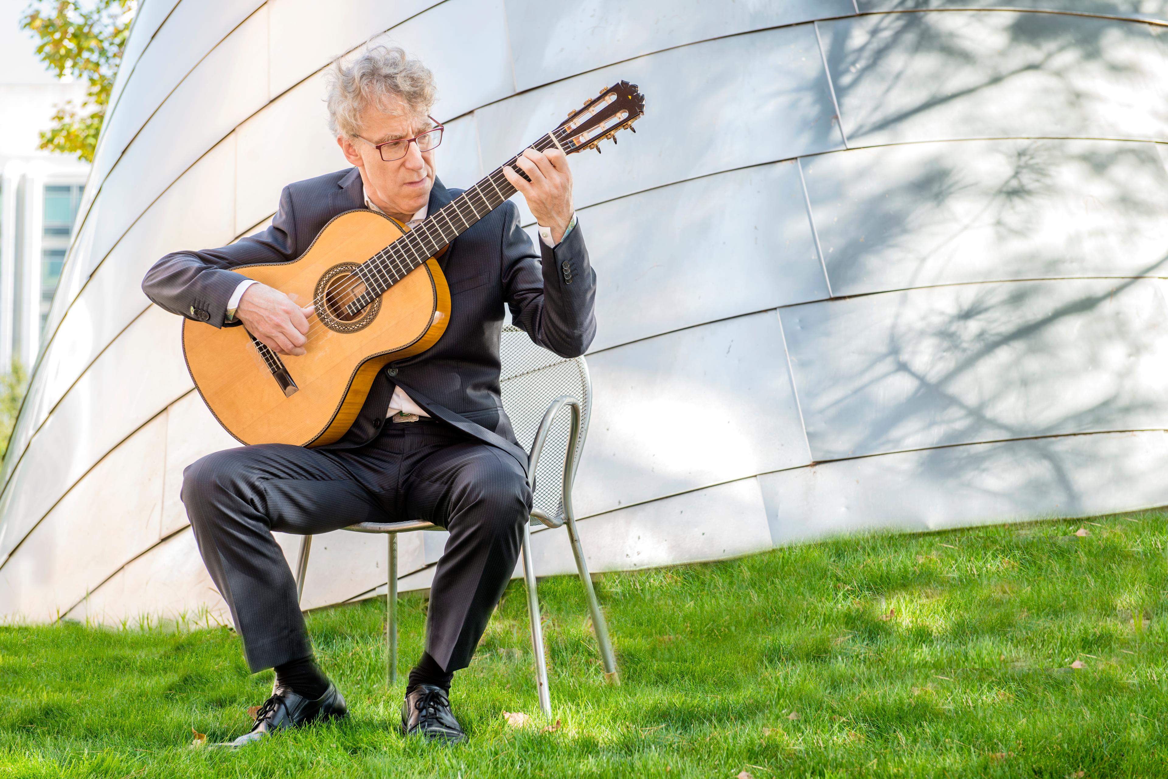 Eliot Fisk playing on green grass